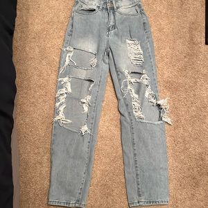 Ripped light wash denim jeans.